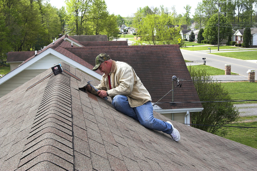 man repairing the house roof