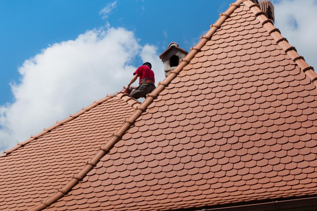 worker on the house roof